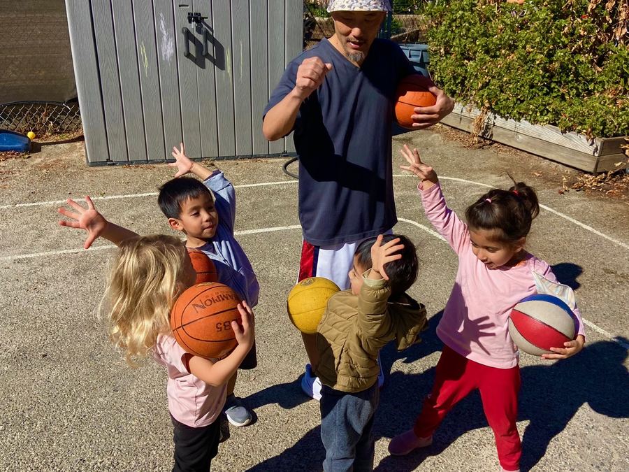 Children playing basketball outdoors