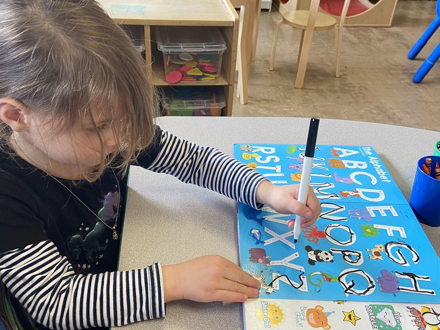 Preschooler tracing letters at ECLA