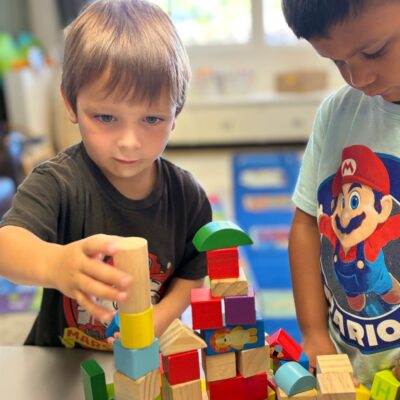 Children building a tower with colorful blocks