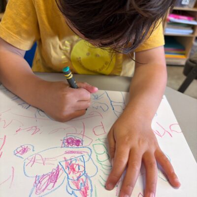 A child drawing with colored pencils