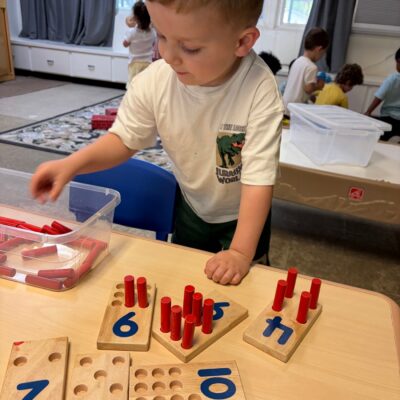 A child counting with number pegs
