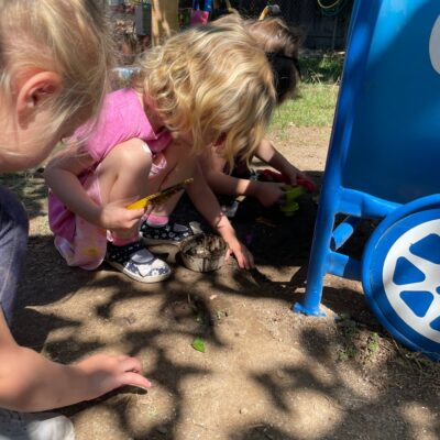 Children exploring together in the sandpit