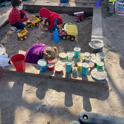 Children building and pouring in the sandpit