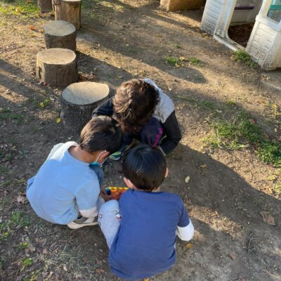 A teacher and children exploring together on the playground